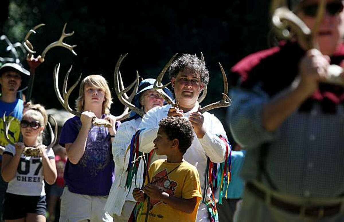 Michael Jones (center, white shirt) marches with over 100 other people participating in a mass antler dance organized by the California Revels at Joaquin Miller Park on Monday Sept. 6, 2010 in Oakland, Calif. The dance, performed for the first time at this park, is part of a 1,000-old-old annual tradition done in Abbots Bromley, England. Some say the strange unexplained dance celebrates the great mystery of life.