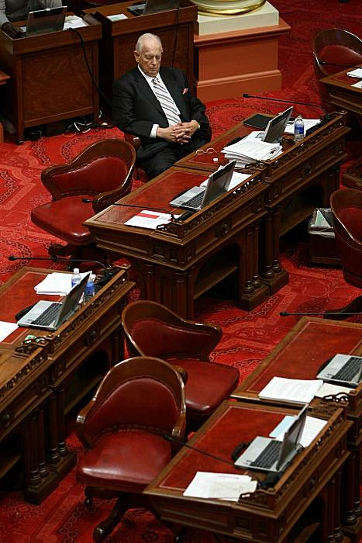 SACRAMENTO, CA - FEBRUARY 18: California State Sen. Dave Cox (R-Fair Oaks) sits alone in the Senate chambers during a recess of the California State Senate February 18, 2009 in Sacramento, California. The California legislature has delayed its vote on a State budget proposal after the GOP party ousted its leader, Dave Cogdill (R-Fresno). The stalled budget caused Governor Arnold Schwarzenegger to issue 20,000 pink slips to state workers and threatens hundreds of state funded public works projects. (Photo by Justin Sullivan/Getty Images)