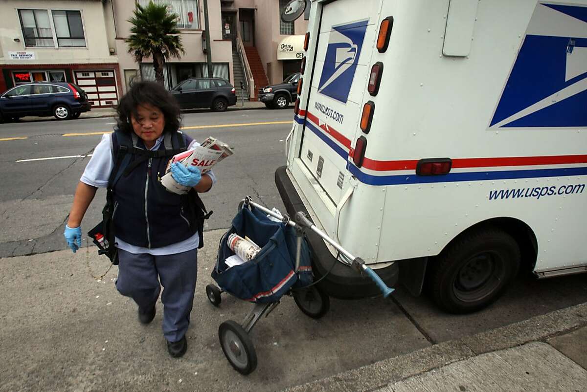Imelda Mancia, technician carrier for the U.S. postal service, delivering mail on the 4900 block of Mission St. in San Francisco, Calif., on Wednesday, January 21, 2009.