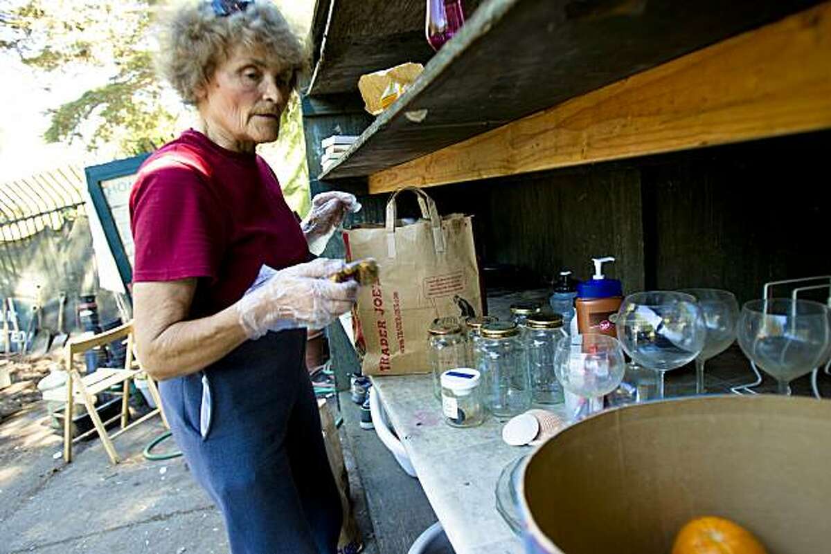 Helen, last name withheld, a volunteer and 20-year patron, organizes the a shelves of various free items at the Haight-Ashbury Neighborhood Council Recycling Center in San Francisco, Calif. on Wednesday, Sept. 1, 2010.