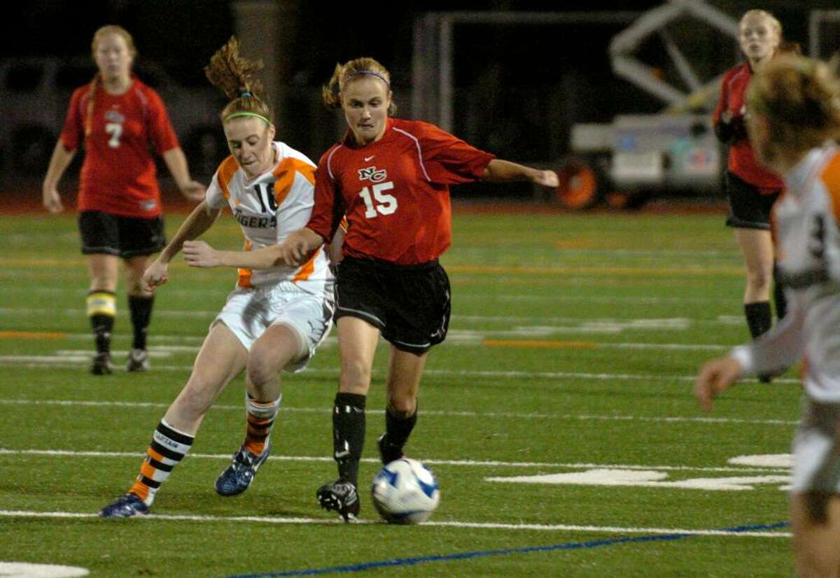 New Canaan's #15 Jana Persky, right, controls the ball as Ridgefield's #16 Kelly Baker tries to intercept, during FCIAC soccer in Norwalk on Wednesday Nov. 04, 2009. Both teams were declared co-champions after double overtime with no score.