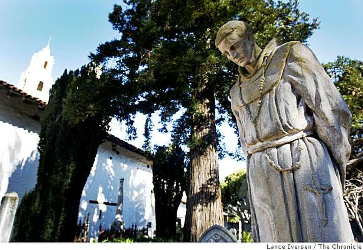 A Statue of Father Junipero Serra stands in the middle of the church cemetery at Mission Dolores in San Francisco Tuesday Jan 13, 2009