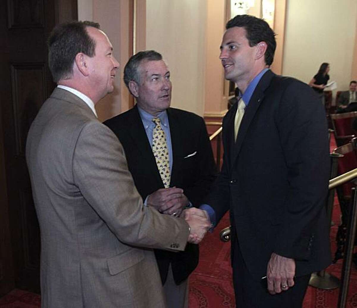 Assemblyman Nathan Fletcher, R-San Diego, right, and Sen. Minority Leader Dennis Hollingsworth, R-Murietta, left, shakes hands on the passage of Fletcher's measure to increase the penalties for convicted child molesters was approved by the Senate, at theCapitol in Sacramento, Calif., Tuesday, Aug. 24, 2010. The bill, known as Chelsea's Law would reserve life-without parole for adult predators who kidnap, drug, bind, torture or use a weapon while committing a sex crime against a child. The bill was named after 17-year-old Chelsea King , who was murdered in San Diego County by a convicted child molestor out on parole earlier in the year. Also seen is Assembly Minority Leader Martin Garrick, R-Solana Beach.