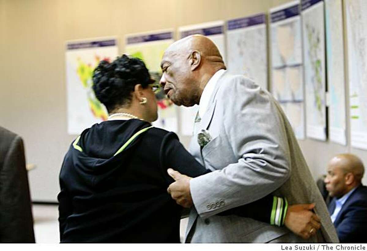 Charlie Walker of San Francisco (right) pulls Bart Board Member Carole Ward Allen (left) aside and talks with her as she reenters the Lawrence D. Dahms Auditorium after leaving during the community meeting in response to the shooting of Oscar Grant at the Joseph P. Bort MetroCenter in Oakland, Calif. on Sunday January 11 ,2009.