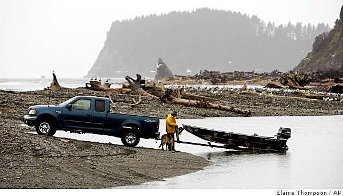 A fisherman prepares to head out onto the Hoh River, where it meets the Pacific, on the Hoh Indian Reservation, Dec. 9, 2008. Heavy rains and severe flooding used to be a problem every five or 10 years on the tiny reservation, but these days it's an annual event and plans are being made to relocate the entire village to higher ground. (AP Photo/Elaine Thompson)