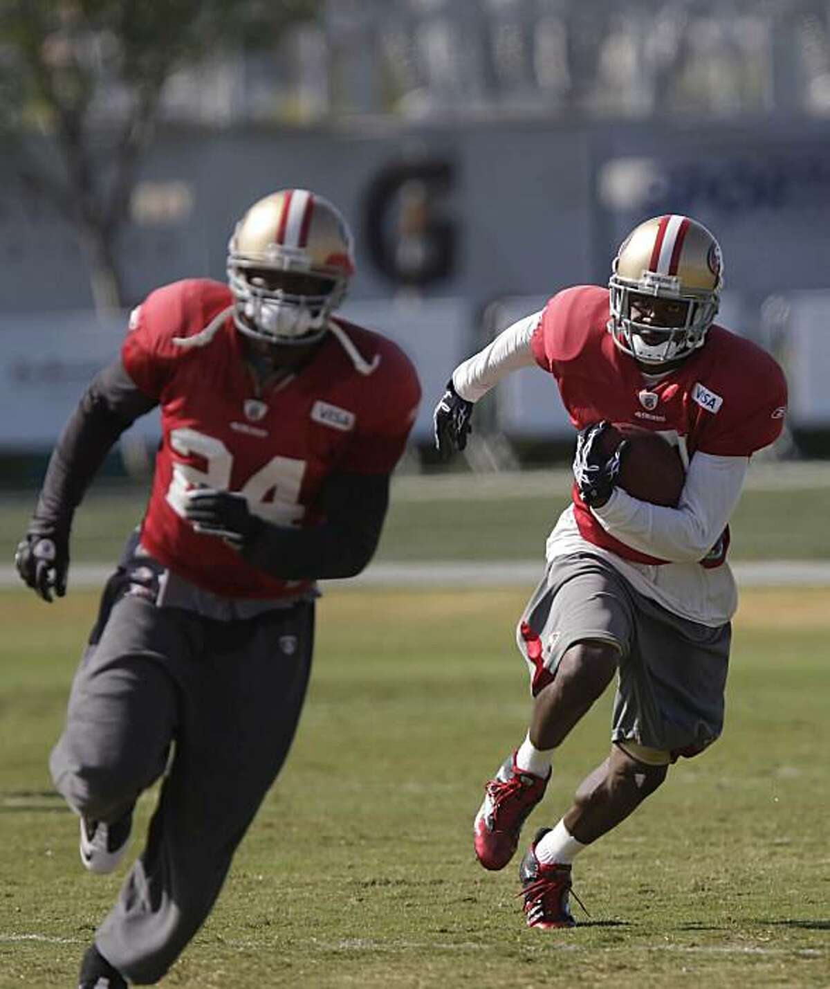 49ers #17 Dominique Zeigler (right) runs with the football during practice at training camp in Santa Clara, Calif. on Thursday August 19, 2010.