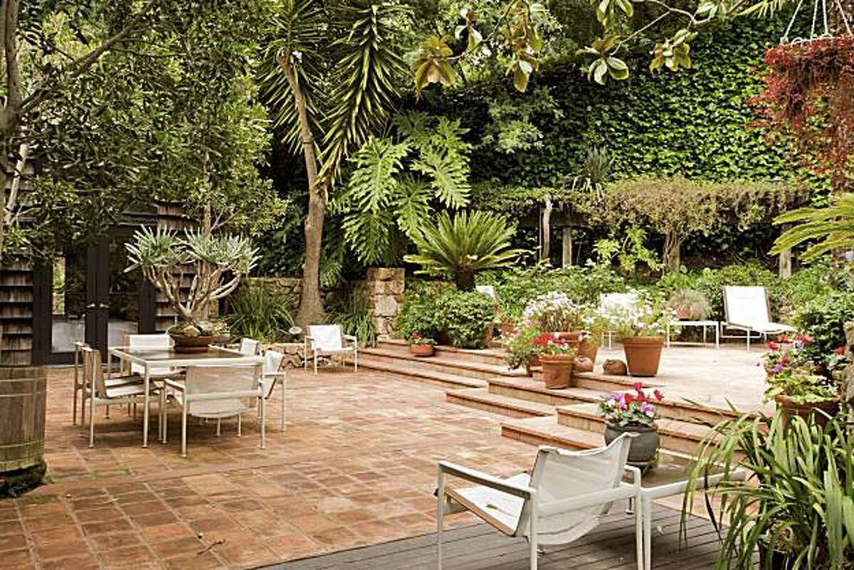 Tropical landscape, stone interior shelter Piedmont home