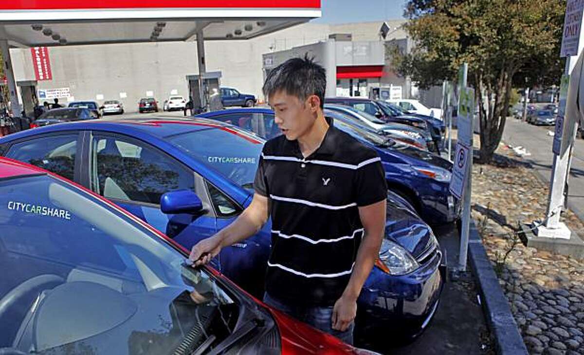 Nathaniel Lee uses an automatic lock to unlock the car as he checks out a car from the carshare program, Monday August 16, 2010, along Market and 15th street, in San Francisco, Calif. He has been using carshare for two years.