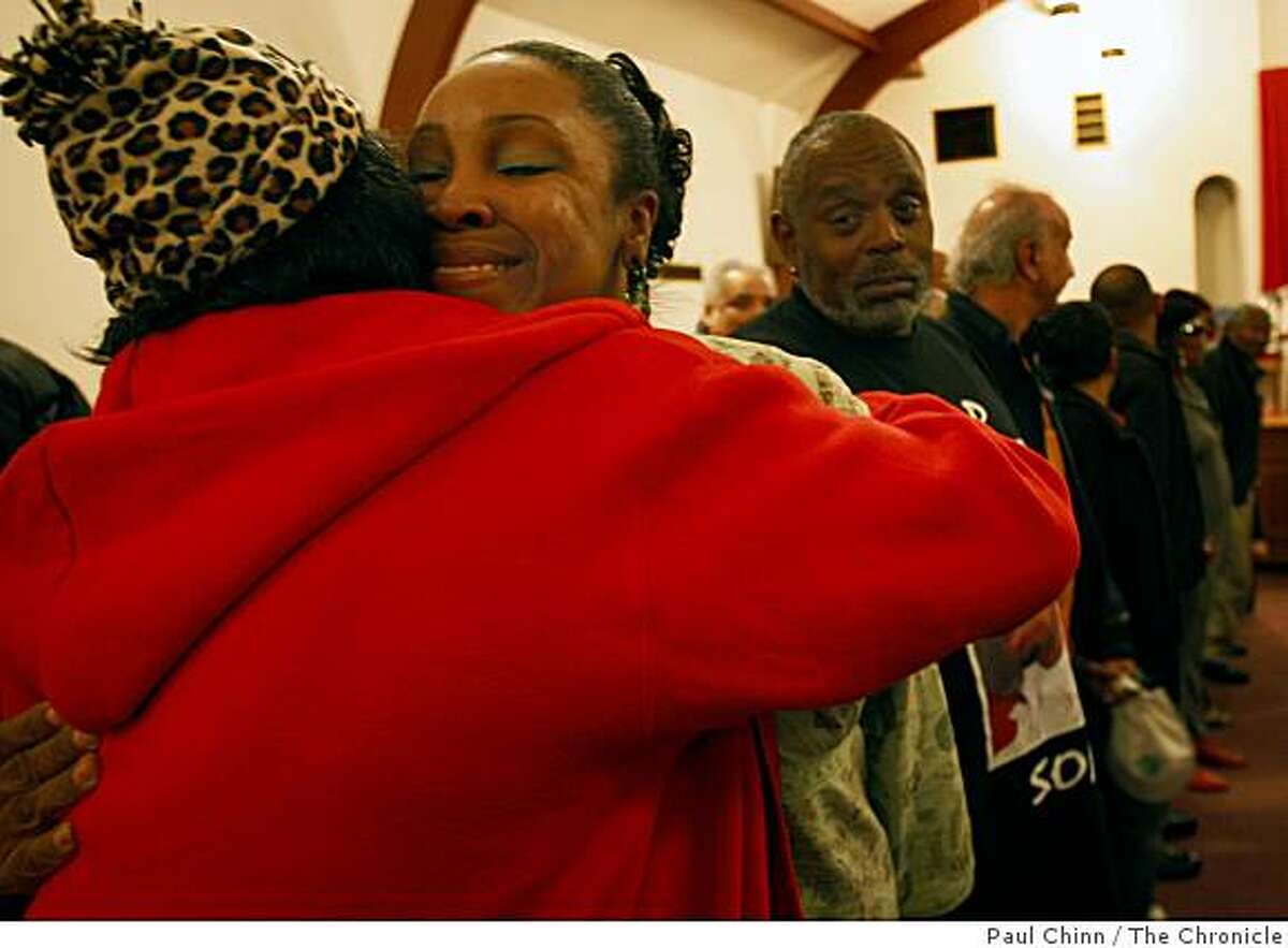 Carolyn Alexander, left, hugs Lenora Ann McCall during a meeting of the Healing Circle support group for survivors of homicide victims in San Francisco, Calif., on Thursday, Dec. 11, 2008. McCall's daughter Milika Fields with killed by gunfire on May 31 of this year. Looking on is Larry Wilson, right.