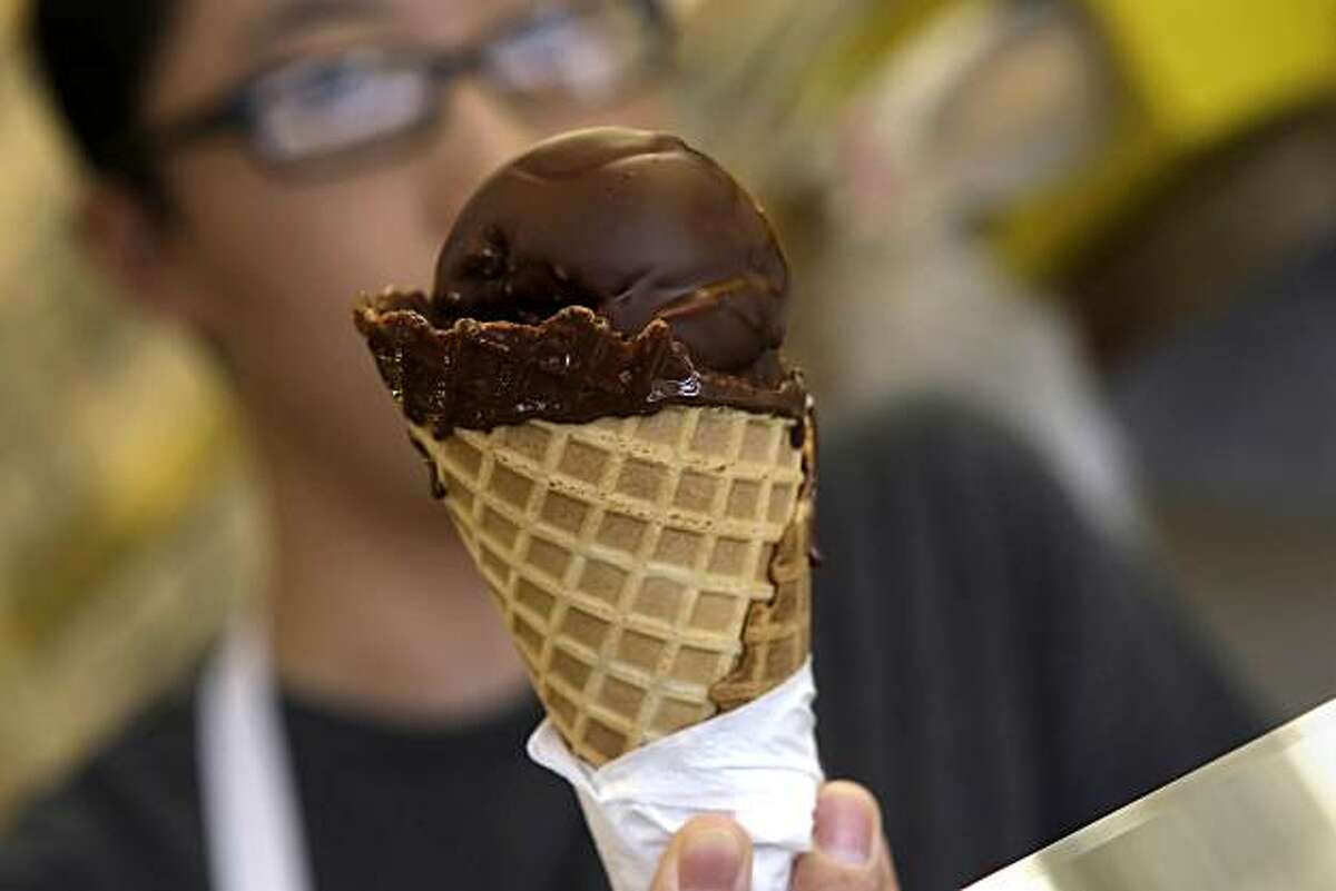 Satsuki Murashige shows off a chocolate dipped ice cream cone as it hardens at Joe's Ice Cream in San Francisco, Calif. on Tuesday August 10, 2010.