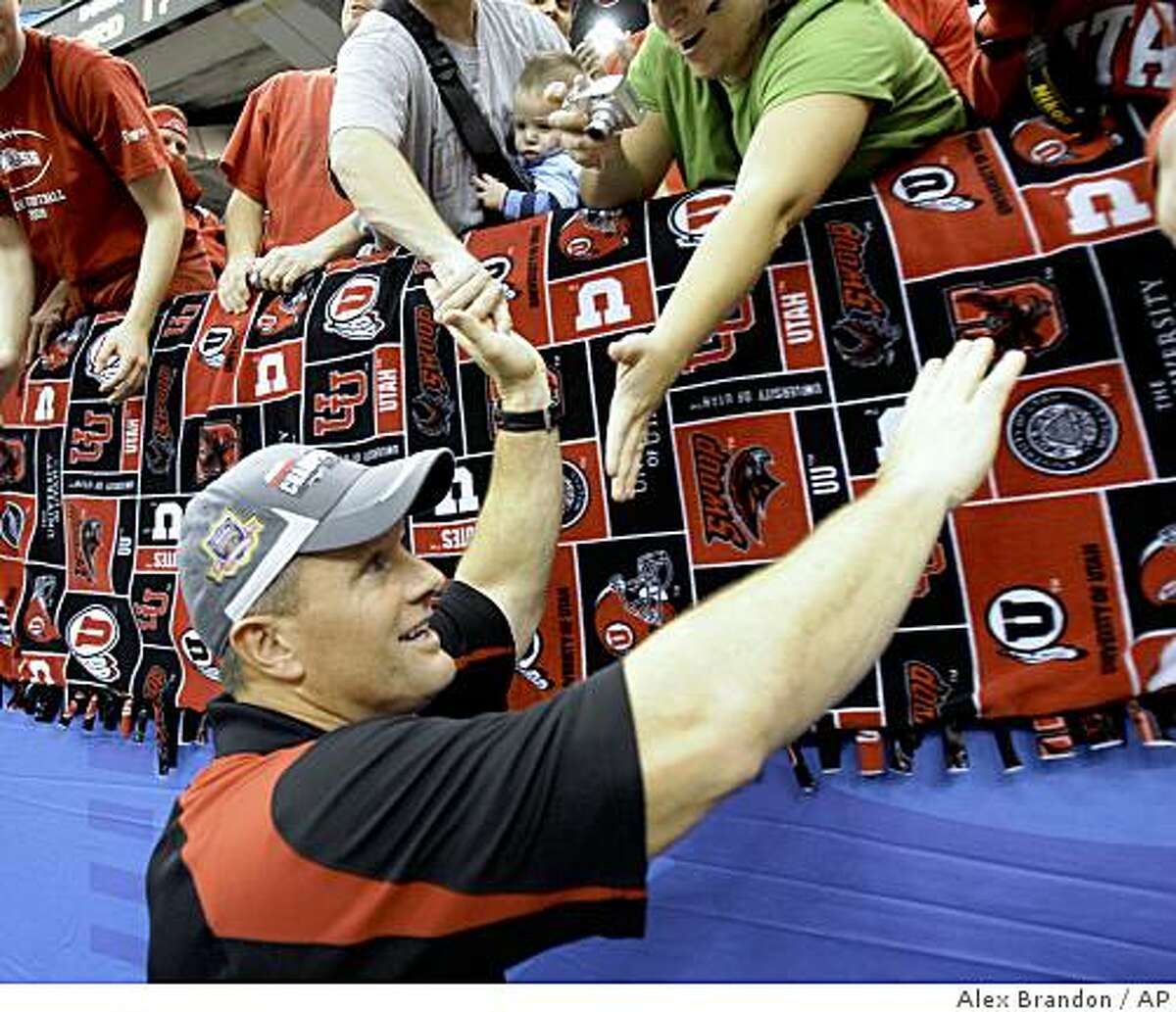 Utah coach kyle Wittingham celebrates with fans after defeating Alabama in the Sugar Bowl in New Orleans, Friday, Jan. 2, 2009. Utah defeated Alabama 31-17.