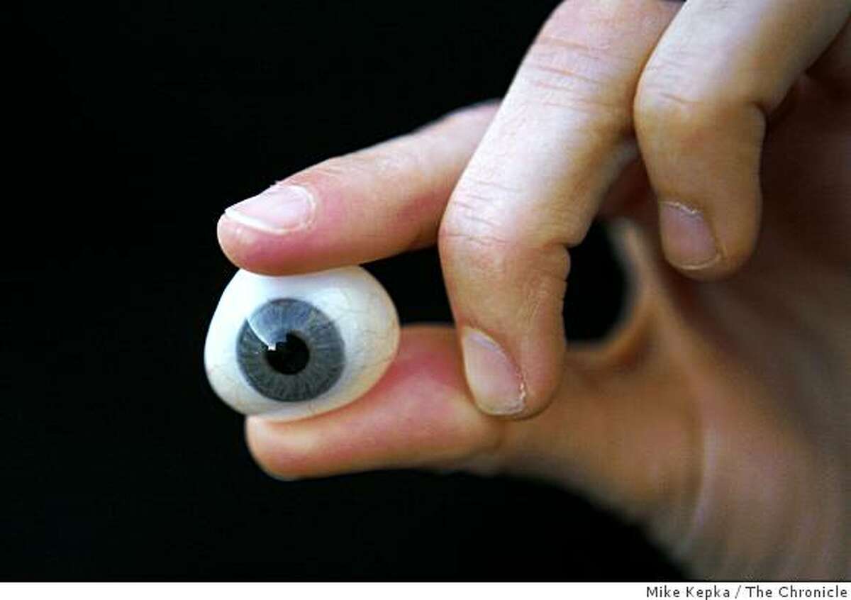 Tanya Vlach, a San Francisco artist who wants to become the first person to implant a video camera behind her prosthetic eye, holds her prosthetic eye for the camera on Thursday Dec. 11, 2008 in San Francisco, Calif.