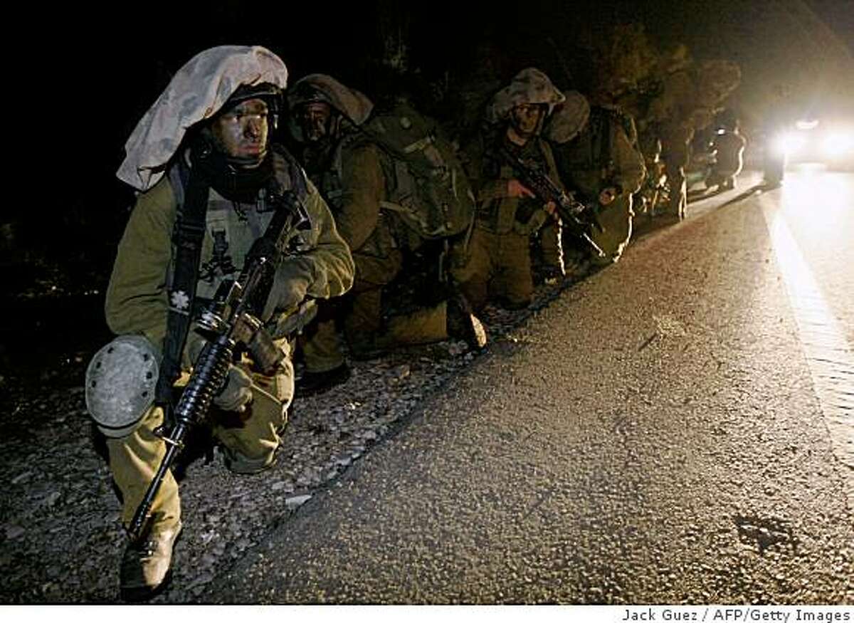 Israeli soldiers maneuver on the Israeli-Gaza border on January 3, 2009, waiting to deploy into the Gaza Strip. Israeli tanks rolled into Gaza late Saturday and troops clashed with Hamas fighters in a step-up to an eight-day offensive that has killed hundreds of Palestinians and caused widespread destruction. The Israeli army said "large numbers" of troops had moved into Gaza and the government called up thousands of reservists to take part in the ground offensive to end rocket attacks by Hamas and its militant allies. AFP PHOTO/JACK GUEZ (Photo credit should read JACK GUEZ/AFP/Getty Images)