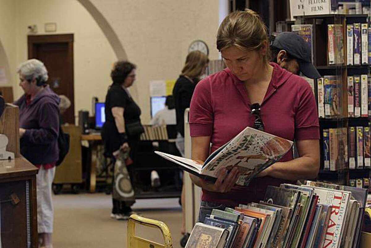 Basia Hajduczek of Berkeley browses through books at the Berkeley Public Library North Branch in Berkeley, Calif. on Wednesday August 4, 2010.
