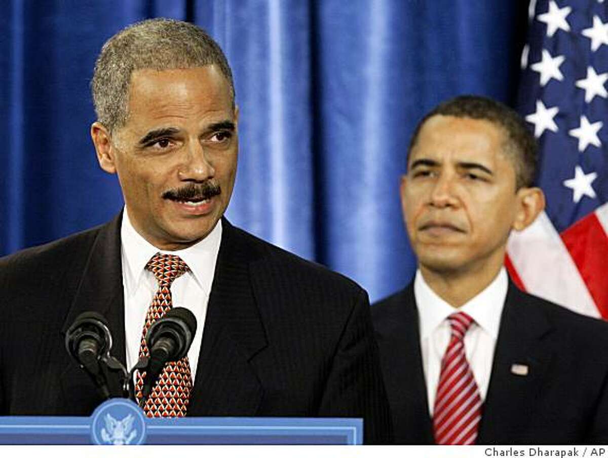 ** FILE ** In this Dec. 1, 2008, file photo, Attorney General-designate Eric Holder speaks during a news conference with President-elect Barack Obama, right, in Chicago. Holder may have to consider removing himself from overseeing the Chicago corruption probe that ensnared Illinois Gov. Rod Blagojevich, legal experts say. Holder was a co-chairman of Barack Obama's presidential campaign, joining it in 2007 when the long-running, high-profile Chicago investigation focused on a businessman who had been among the biggest fundraisers for Obama and Blagojevich. (AP Photo/Charles Dharapak)