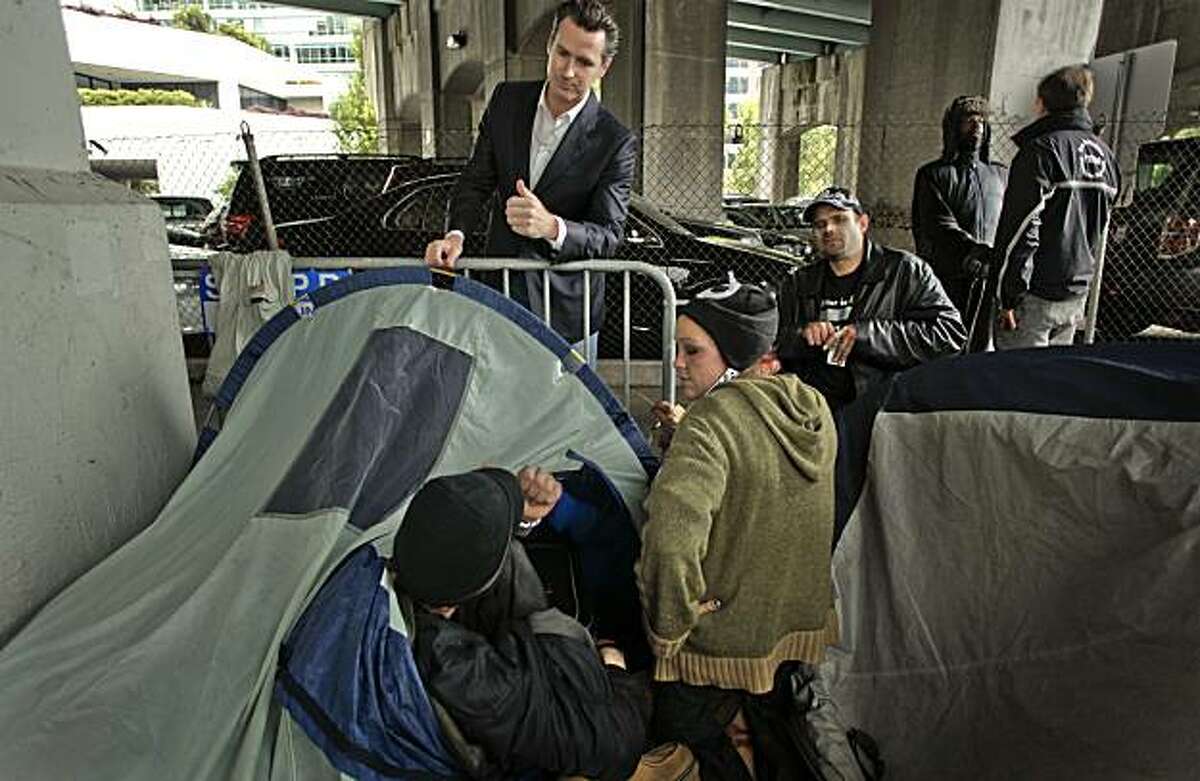 Mayor Newsom meets with a group of homeless camped out under the transbay terminal overpass on Beale Street. Mayor Gavin Newsom tours the Transbay Terminal in San Francisco, Ca. on Friday July 30, 2010, meeting with homeless who are in need of city services such as shelter, food and healthcare.