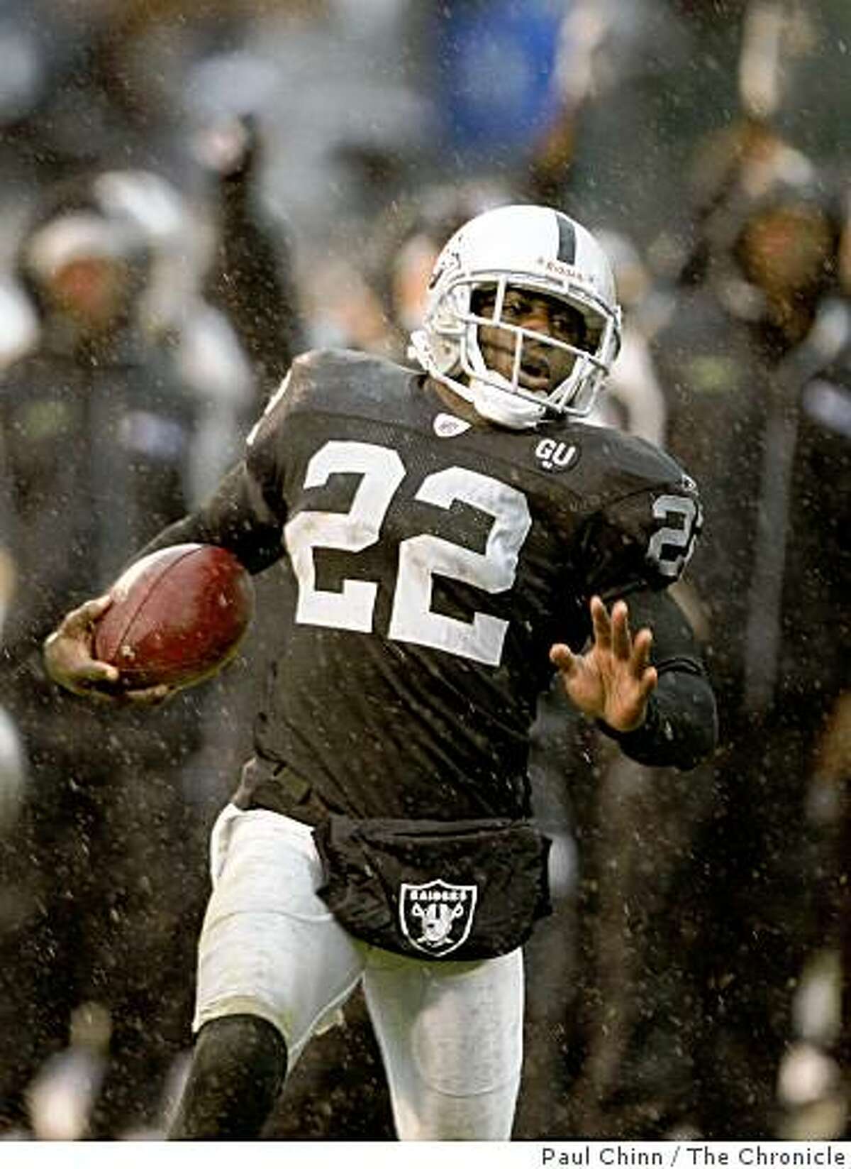 Justin Miller heads for the end zone on his 91-yard kickoff return in the second quarter of the Oakland Raiders vs. New England Patriots NFL football game in Oakland, Calif., on Sunday, Dec. 14, 2008.