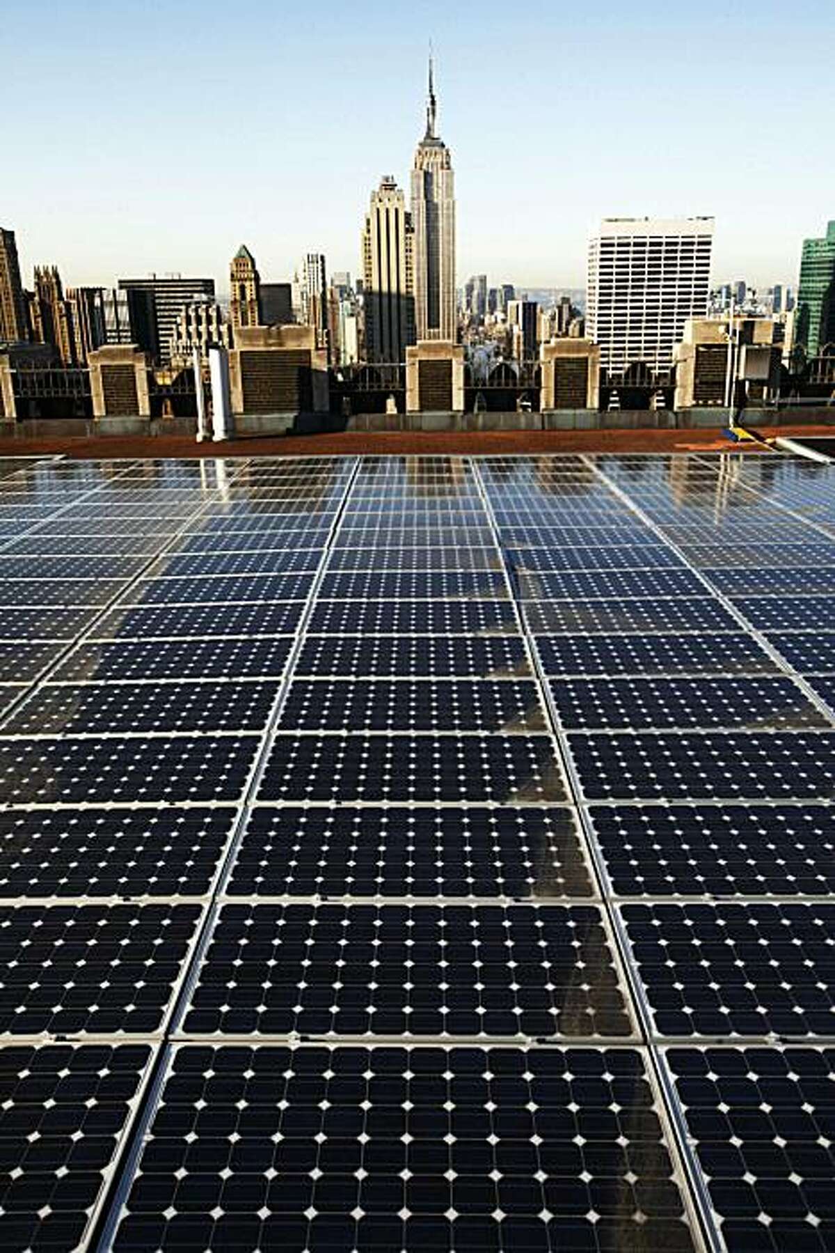 In this March 24, 2009 photo, solar panels are in place on a Rockefeller Center rooftop in midtown Manhattan in New York. The fledgling renewable energy industry has surged over much of the past decade, adding jobs at more than twice the national rate, according to a Pew Charitable Trusts study released Wednesday, June 10, 2009.(AP Photo/Mark Lennihan)