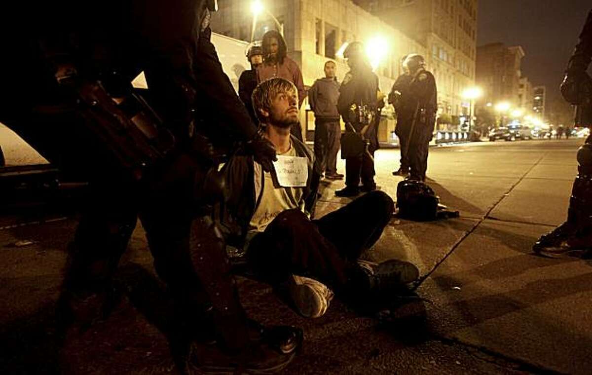 Sam Whitman is processed on the scene after being arrested during the protest in downtown Oakland, Ca., on Thursday July 8, 2010, in support of Oscar Grant, after former BART police officer, Johannes Meserle, was found guilty of involuntary man slaughter in the killing of Grant.