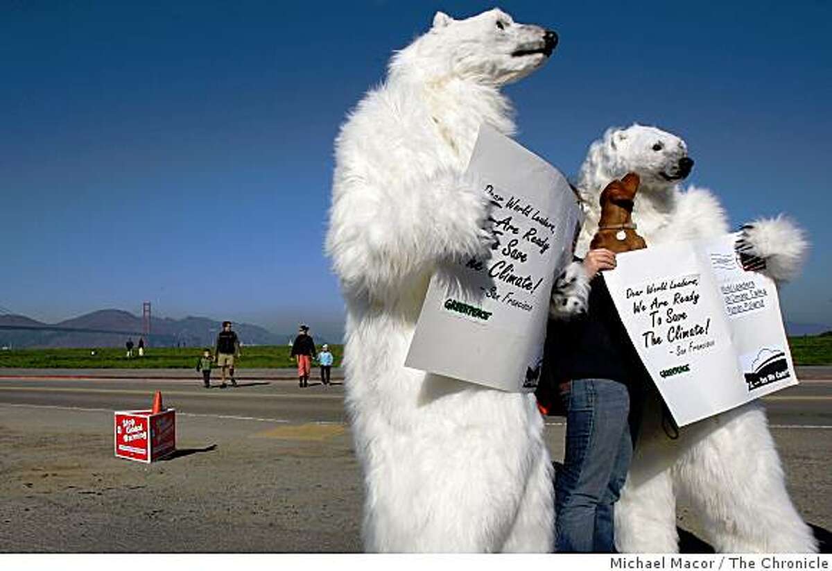 Lauren Purnell and her dog, "Ellis" stop by to greet two polar Bears on hand with dozens of other people on the great lawn at Crissy Field in San Francisco, Calif. on Saturday Dec. 6, 2008, to tell the world they are ready to fight global warming. They later created a postcard with a message that will be sent to colleagues who are attending the United Nation's Climate Talks in Poznan,Poland. The card reads, "Dear World Leaders, We Are Ready to save the climate! Yes We can!".