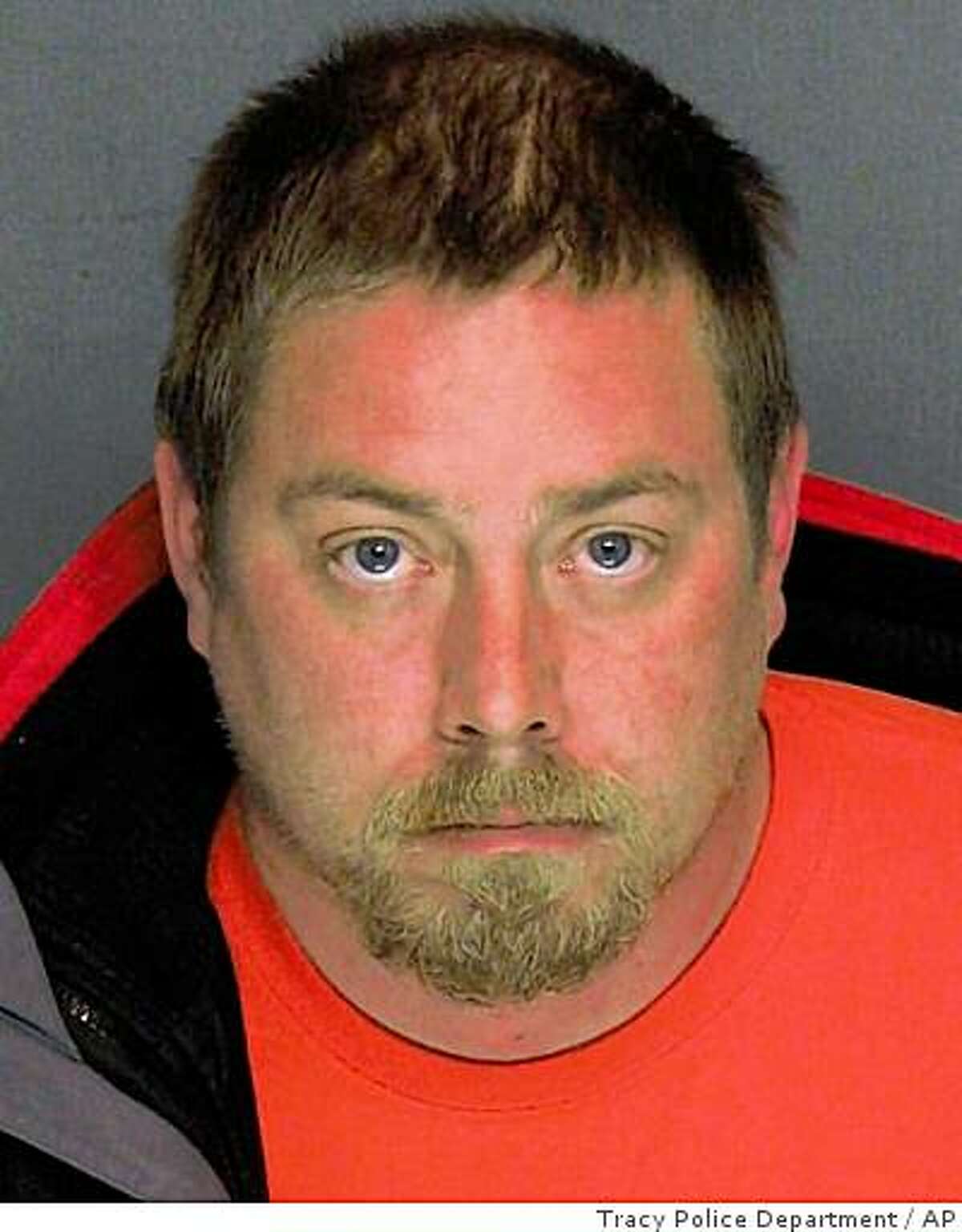In this handout photo provided by the Tracy Police Department, the booking mug for Michael Schumacher, 34, is shown. Schumacher, and wife Kelly Layne Lau, 30, were arrested late Monday, charged with torture and other counts after a bruised, terrified 17-year-old showed up at a gym with a chain locked to his ankle, claiming he had just fled his captors, authorities said Tuesday. (AP Photo/Tracy Police Department)