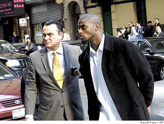 Giants' Burress is cuffed, booked in N.Y.