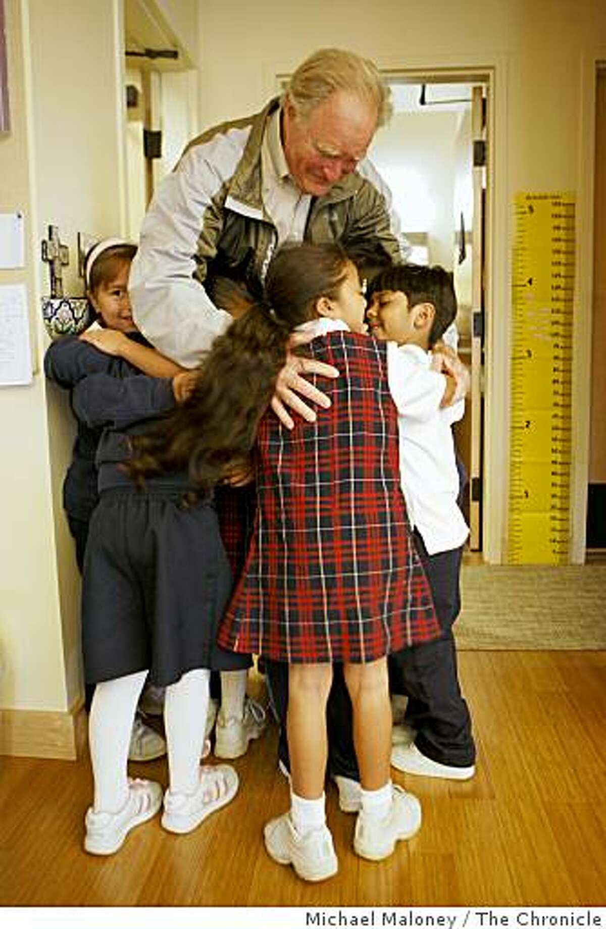 Philanthropist Bill Somerville gets a hug from the Holy Family School students at the St. Francis Center in Redwood City, Calif., on November 19, 2008 - one of the many organizations he has helped out. The first graders all ran to him yelling "Mr. Bill!" on his visit to the class.