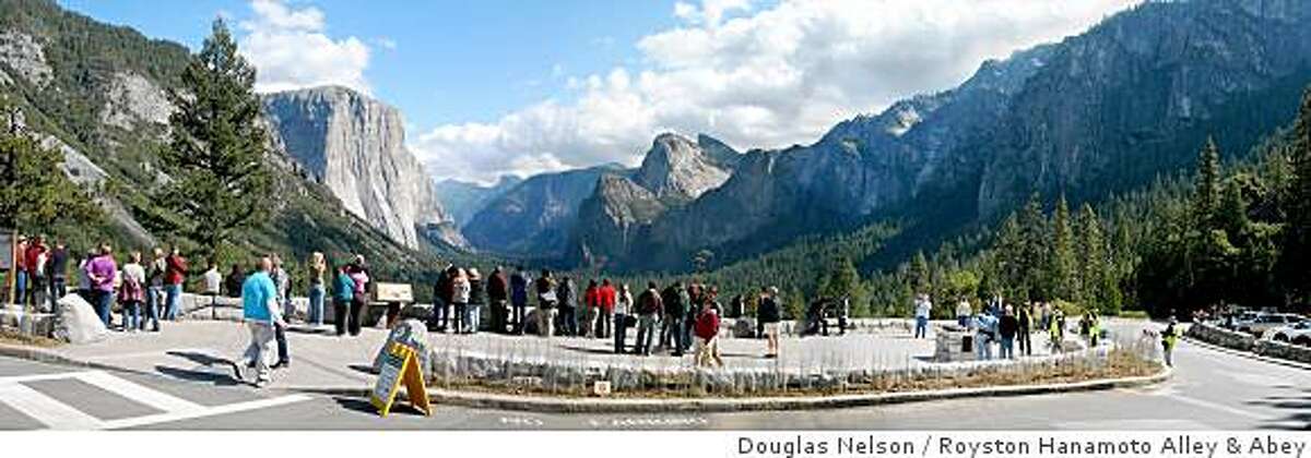 Tourists look out at Half Dome in Yosemite National Park at the newly redesigned Tunnel View Overlook on October 10, 2008. A half dozen trees were removed and a dedicated viewing area was built to give tourists easier access to the picturesque viewing spot.