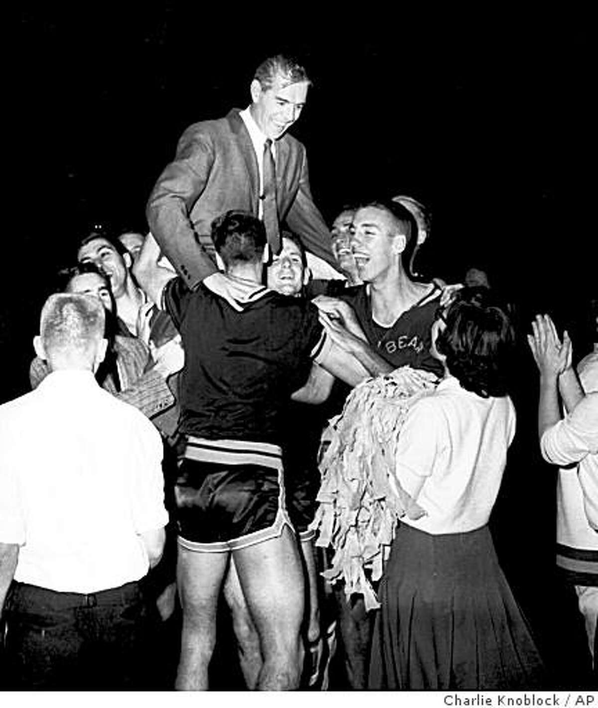 A smiling coach Pete Newell is hoisted to shoulders of members of the California Bears basketball team March 21, 1959 after they won a close, 71-70 decision over West Virginia at Louisville,Ky. to became NCAA champs.