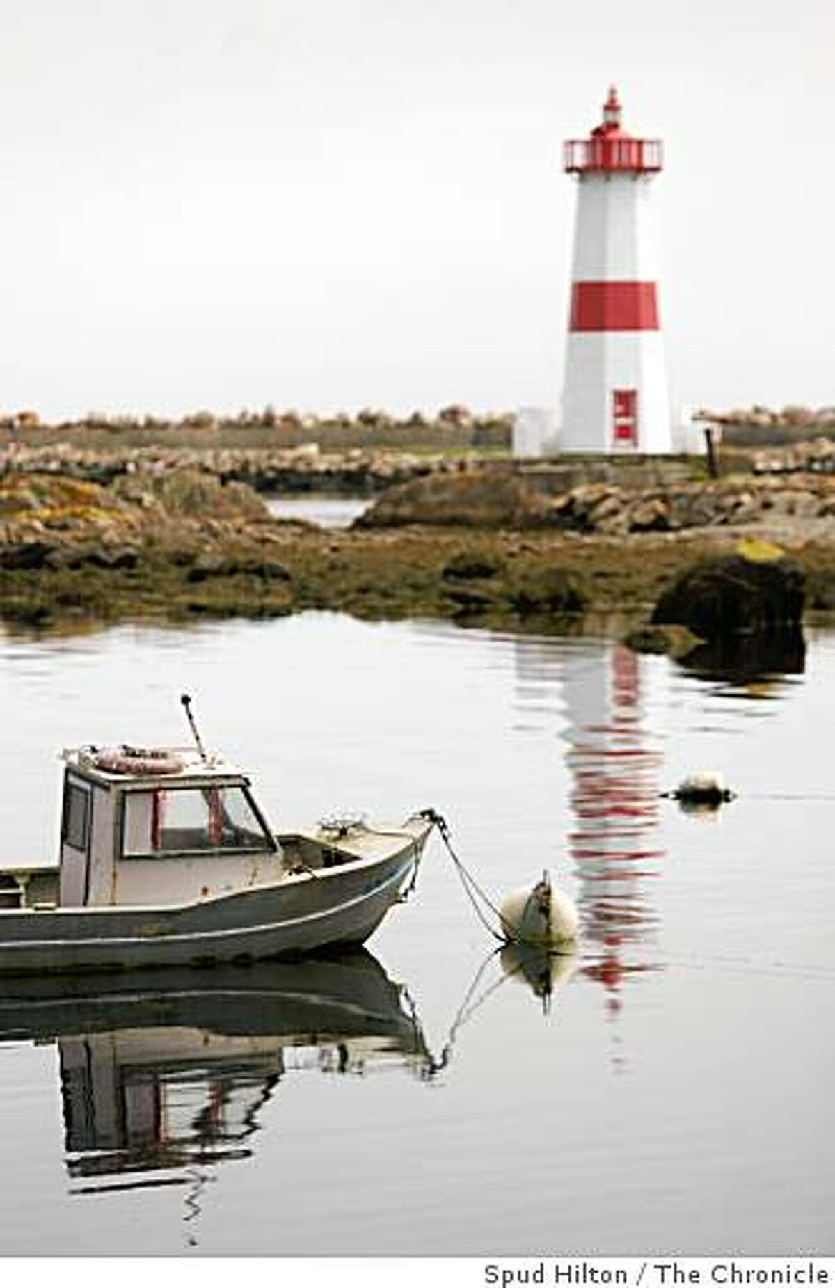 The lighthouse at Pointe aux Canons looms over the harbor in Saint-Pierre. Saint-Pierre et Miquelon, an eight-island archipelago off the coast of Newfoundland, Canada, that is technically French soil. It is a blend of Icelandic weather and geography and rural Normandy culture.SPECIFIC CUT TK.7/18/08 in Saint-Pierre, Saint-Pierre et Miquelon.travel_stpierre20.jpg