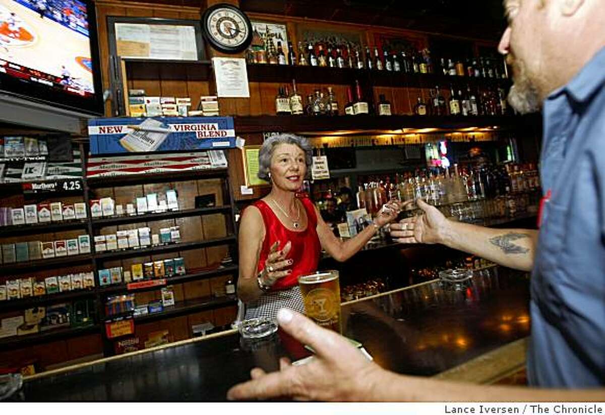 Beverly Swanson, president of Calif licensed Beverage Association, and a bar owner for the past two decades, serves her customers at the family owned tavern One Double Oh Seven Club & Smoking Parlor in Santa Cruz. She talks with Larry Goody a customer for the past 20 years regarding the proposed changes in the tax laws on Friday afternoon November 14, 2008.