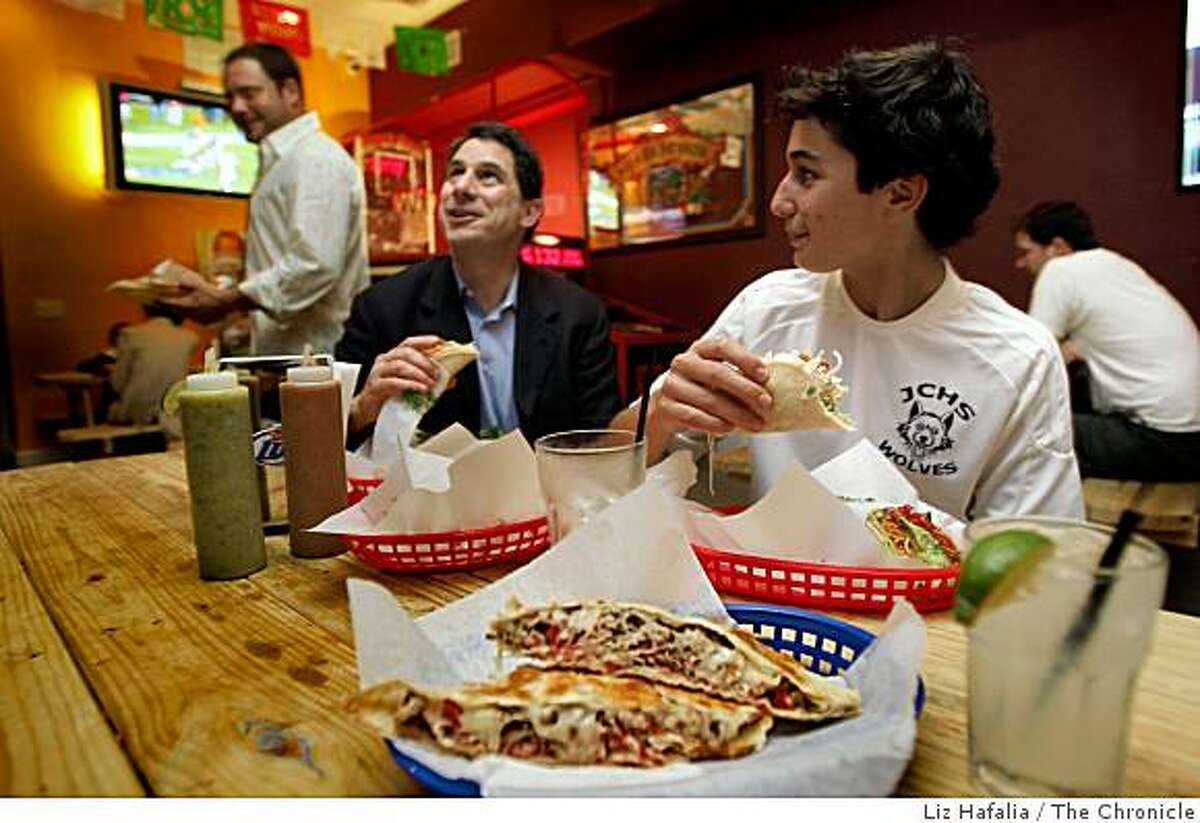 Merle Malakoff (left) and his son Max Malakoff, 14, having a fish taco and chicken taco, while a quesadilla and margarita are in front at Underdogs Sports Bar & Grill in San Francisco, CA., on Thursday, November 6, 2008.