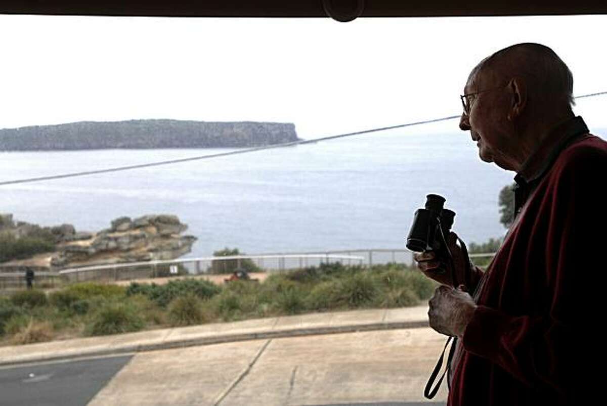 In this photo taken May 25, 2010, Don Ritchie looks out his window at his home in Sydney, Australia. For almost 50 years Ritchie, widely regarded as a guardian angel, has used simple kindness to shepherd countless suicidal people away from the edge. ( AP Photo/Jeremy Piper)