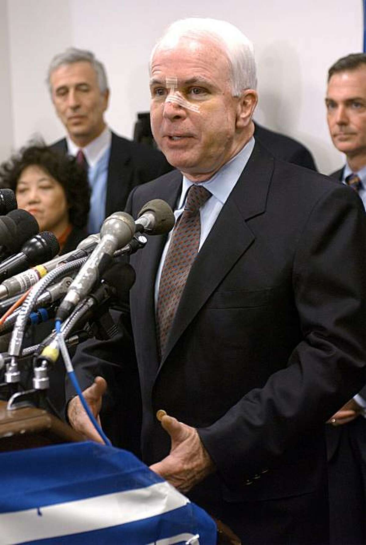 ** FILE** In this Feb. 11, 2002 file photo, a bandaged Sen. John McCain, R-Ariz., takes part in a Washington news conference to discuss campaign finance. Three-time melanoma survivor John McCain appears cancer-free, has a strong heart and is in otherwise general good health, according to eight years of medical records reviewed by The Associated Press. (AP Photo/Stephen J. Boitano)
