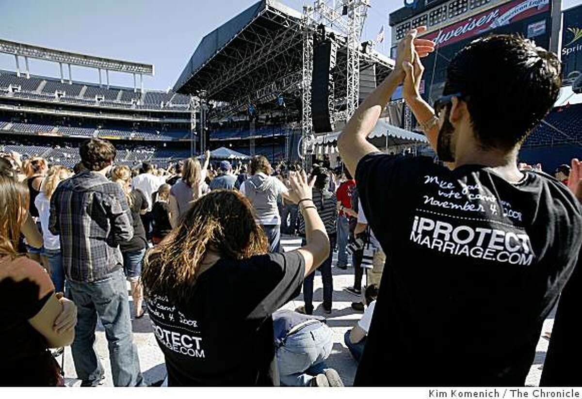 Two people wearing shirts reading "Make Your Vote Count on November 4, 2008, IPtotectmarriage.com" are among the participants in "The Call" a fast and prayer gathering attended by thousands at Qualcomm Stadium in San Diego, Calif., on Saturday, Nov. 1, 2008. While not a political event, "The Call" co-founder Lou Engle exhorted the audience to "pray for California" several times during early hours of the 12 hour nonstop service. Audience members were asked not to bring political signs.