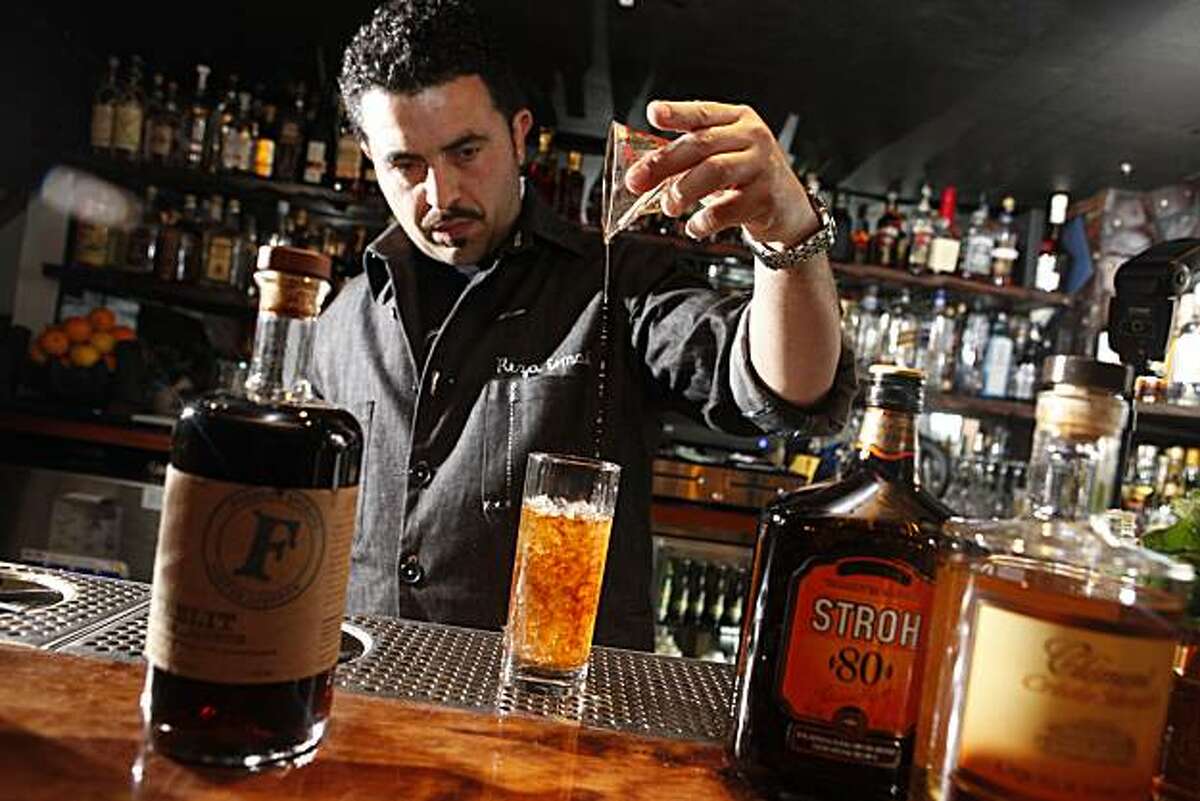 Reza Esmaili, bar tender at Smuggler's Cover, makes a Rear Admiral's Swizzle, which showcases a coffee liquor called Firelit, on Thursday May 20, 2010 in San Francisco, Calif.