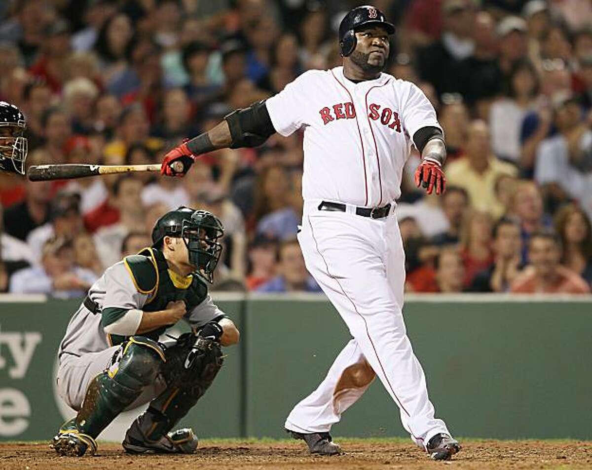 BOSTON - JUNE 02: David Ortiz #34 of the Boston Red Sox watches his two run homer in the fifith inning as Kurt Suzuki #8 of the Oakland Athletics defends on June 2, 2010 at Fenway Park in Boston, Massachusetts.