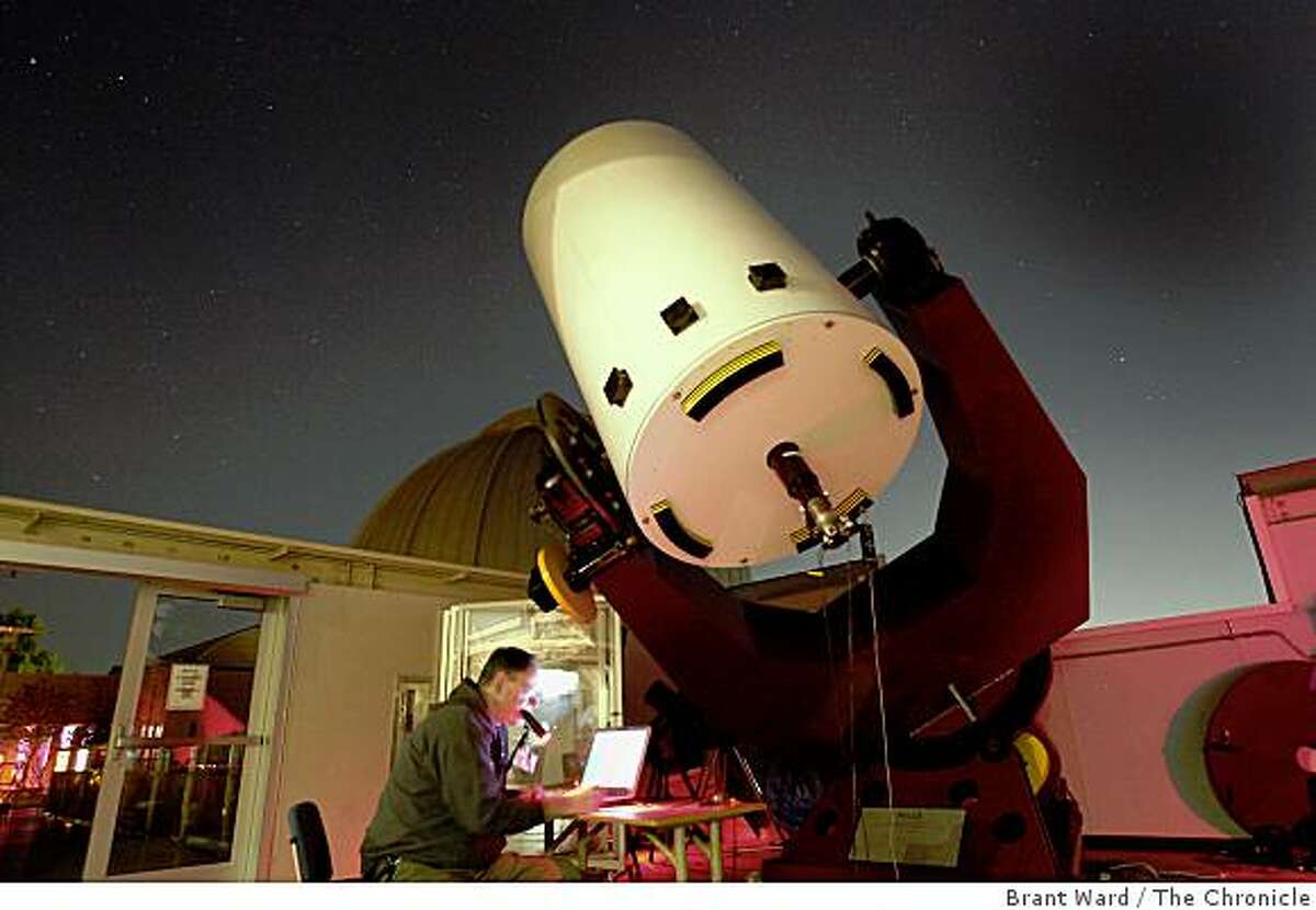 Astronomer Gerald McKeegan looks over his computer as he analyzes photos taken of asteroids. Two official trackers of wayward asteroids, Gerald McKeegan and Conrad Jung, gather at the Chabot Space and Science observatory every couple weeks to watch and track asteroids Wednesday October 22, 2008.