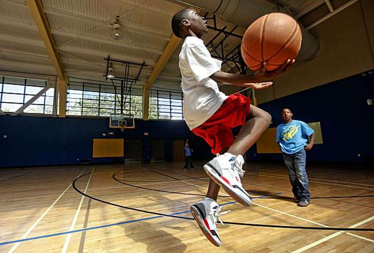 12-year-old Tyrese Johnson, (left) and 11-year-old Ivory Bivins shoot hoops on Monday May, 11, 2010, they are part of an after school program at Hamilton Recreation Center Mayor Gavin Newsom, at the Hamilton Recreation Center in San Francisco, Calif., announced today that the city is expanding summer youth programs to help make up for the decline in the San Francisco Unified School District's summer programs as a result of state budget cuts.