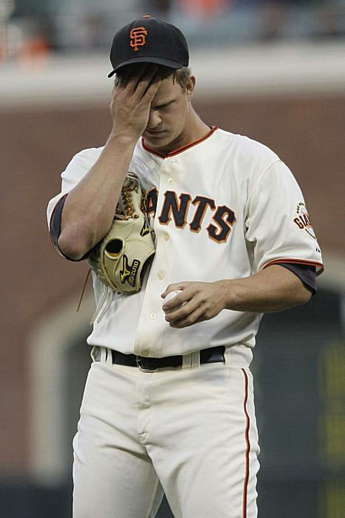 Matt Cain reacts after walking San Diego Padres' Jerry Hairston Jr. to load the bases in the second inning in San Francisco on Wednesday.