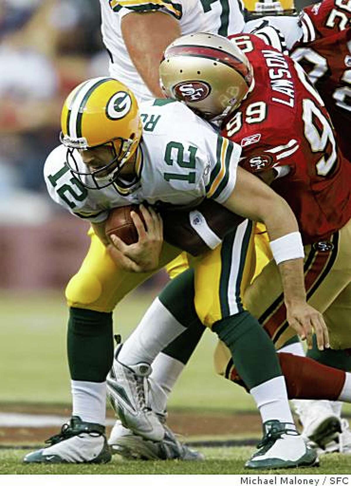 Green Bay Packers quarterback Aaron Rodgers is sacked by 49ers Manny Lawson in the 1st quarter.The San Francisco 49ers host the Green Bay Packers in an NFL preseason game at Candlestick Park in San Francisco, Calif., on August 16, 2008.