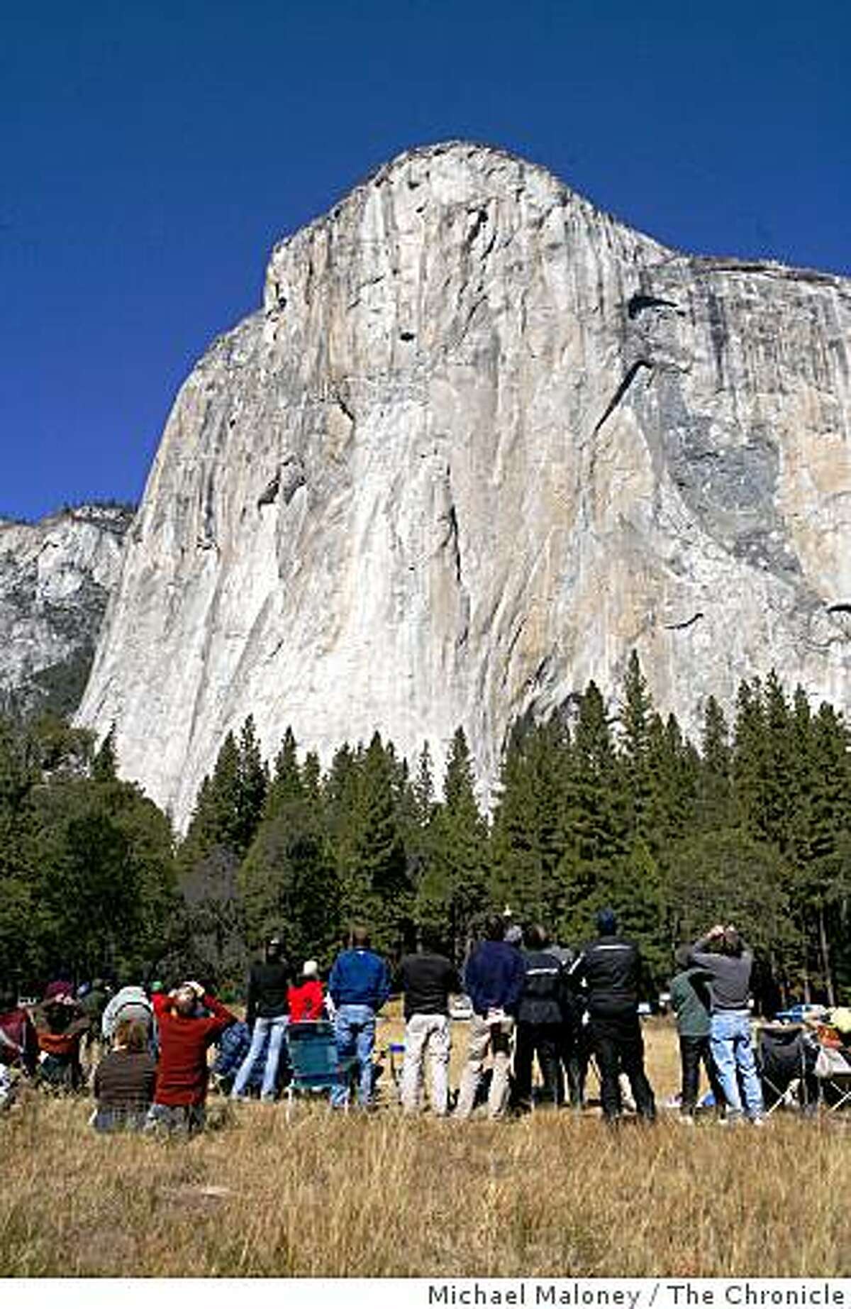 In this file photo, spectators watch climbers on El Capitan in Yosemite National Park.