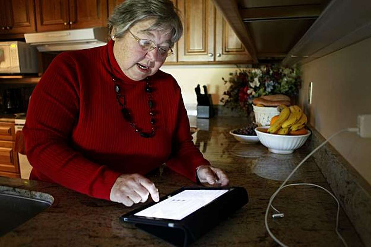 Rita Schena, 78, checks email on her new iPad at her home on Thursday April 29, 2010 in Menlo Park, Calif. Schena said she is very excited to have this device and feels its perfect for seniors on the go.