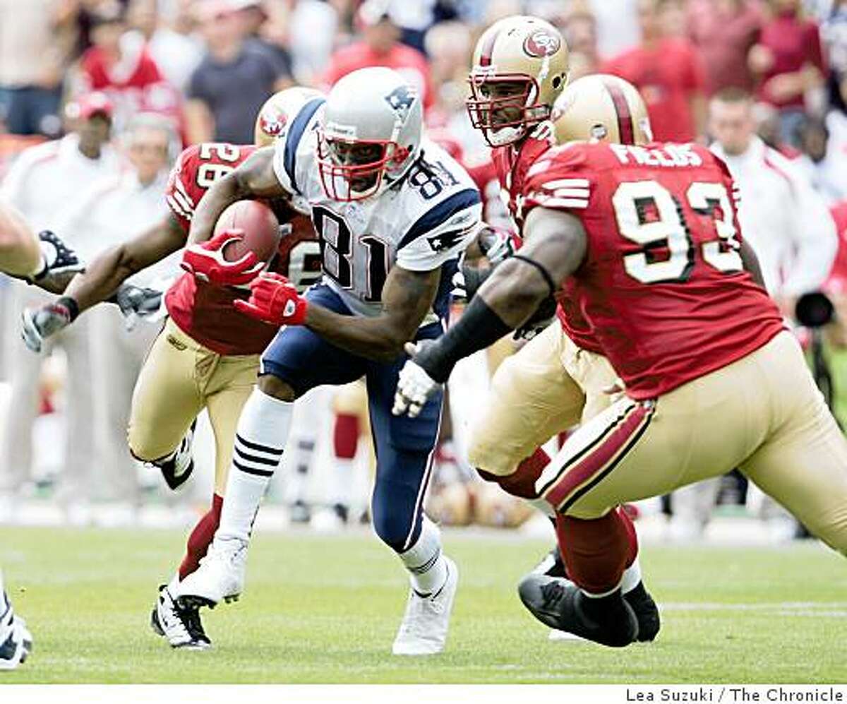 New England Patriots Randy Moss (81) runs up the field for yardage during the first half on Sunday, October 5, 2008 in San Francisco, Calif as the 49ers try to stop him. Final score: San Francisco 49ers 21 to New England Patriots 30.