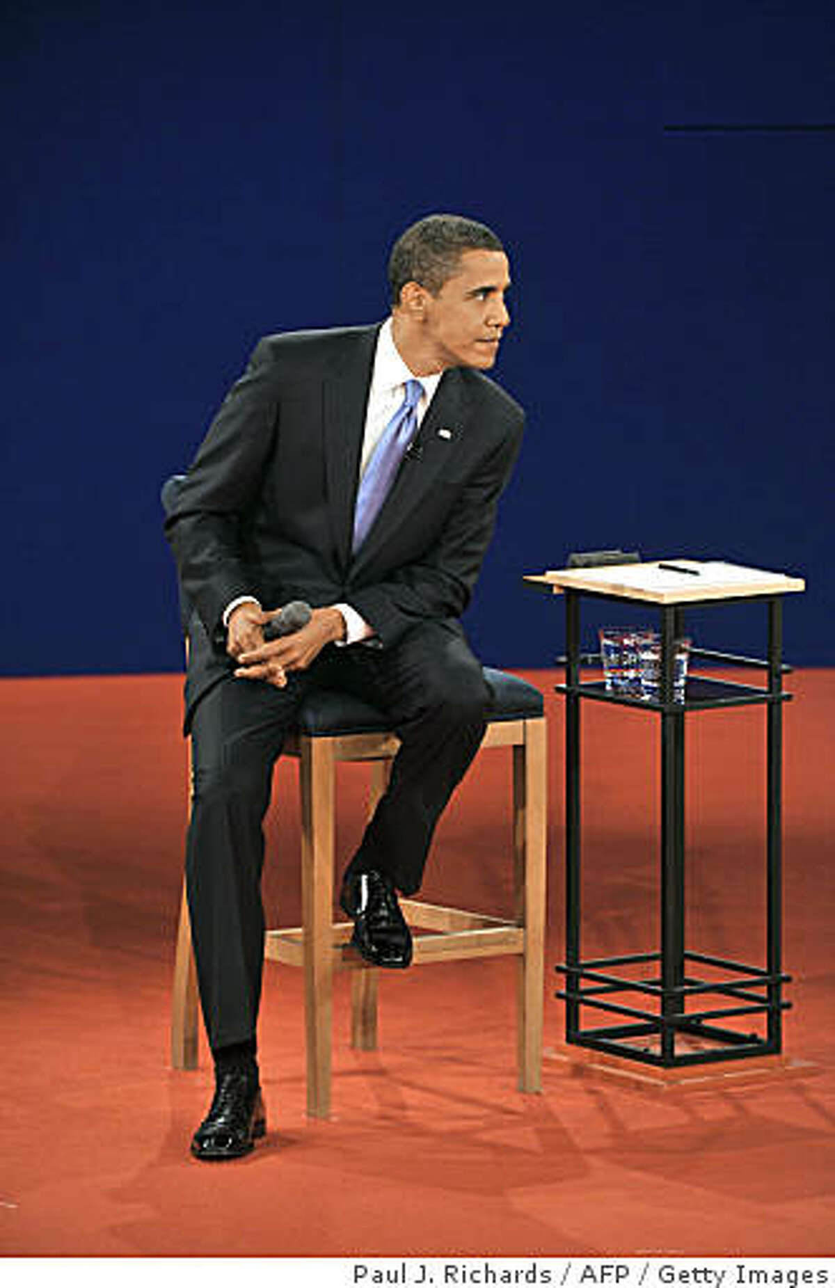 Democrat Barck Obama listens to Republican John McCain during their second presidential debate at Belmont University's Curb Event Center on October 7, 2008 in Nashville, Tennessee.