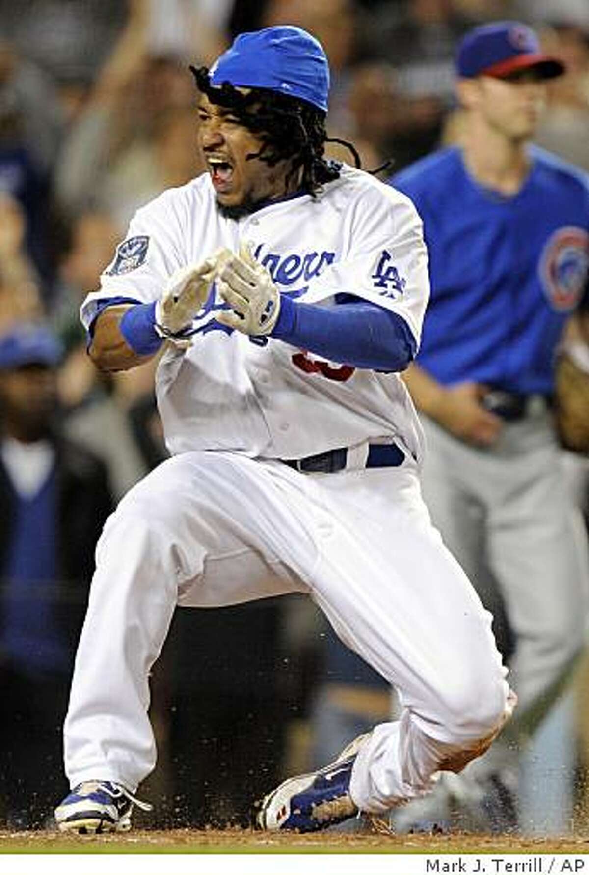 ** FILE ** In this Oct. 4, 2008 file photo, Los Angeles Dodgers' Manny Ramirez reacts after sliding safely into home to score on a two-run double by James Loney during the first inning of Game 3 of baseball's National League division series in Los Angeles, Calif. Ramirez and the Dodgers open the best-of-seven NL championship series against the Philadelphia Phillies, Thursday, Oct. 9, 2008 in Philadelphia. (AP Photo/Mark J. Terril, Fie)