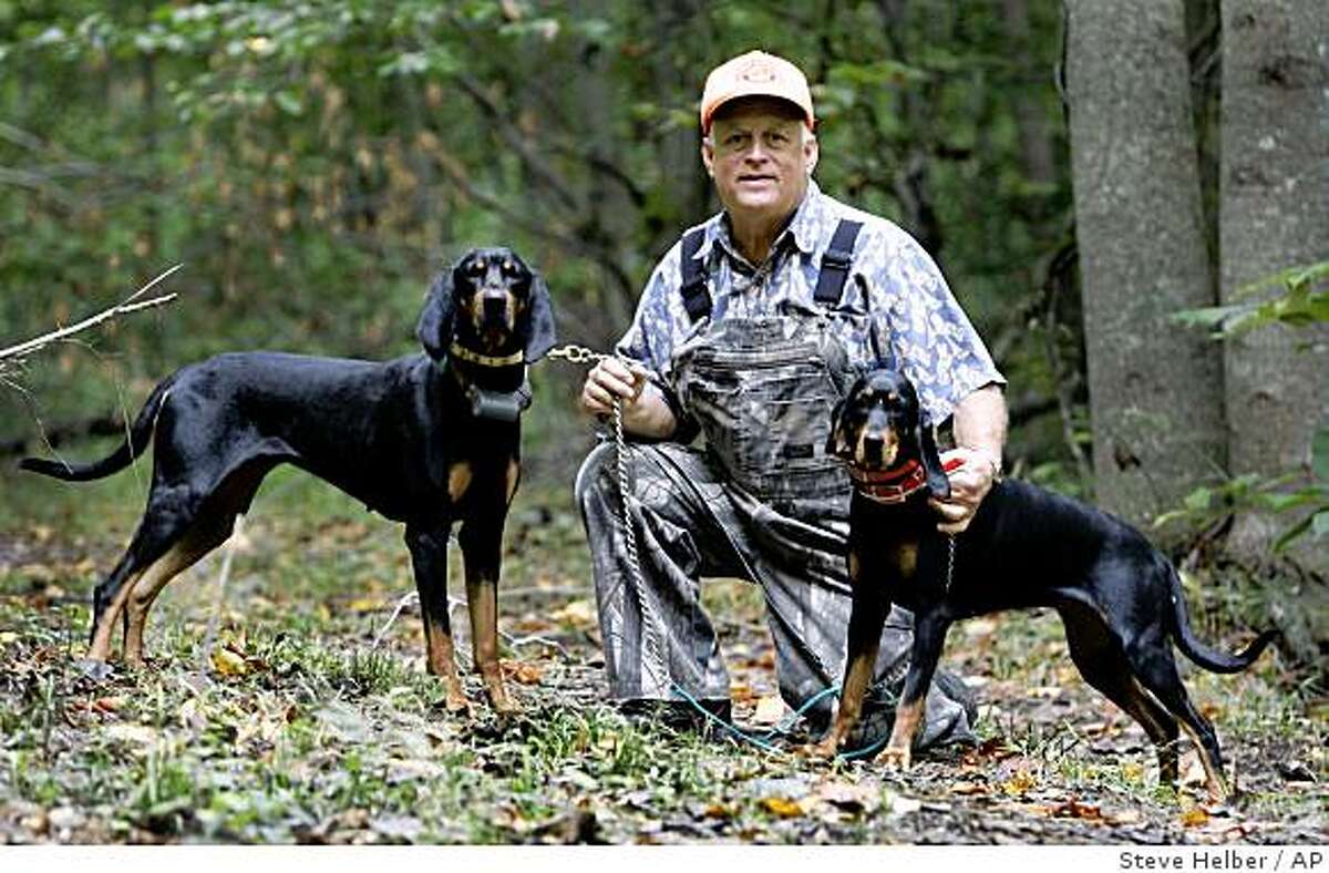 Retired veterinarian David Birdsall poses with two of his Black and Tan hunting dogs, Lady, left, and Jewel, right, on his property at his home in Gloucester, Va., Friday, Sept. 12, 2008. Hunting with hounds in Virginia dates nearly to the founding of Jamestown, America's first permanent English settlement. A Humane Society, report concluded, "the practice of hunting animals with hounds is unsuitable in modern-day Virginia." (AP Photo/Steve Helber)