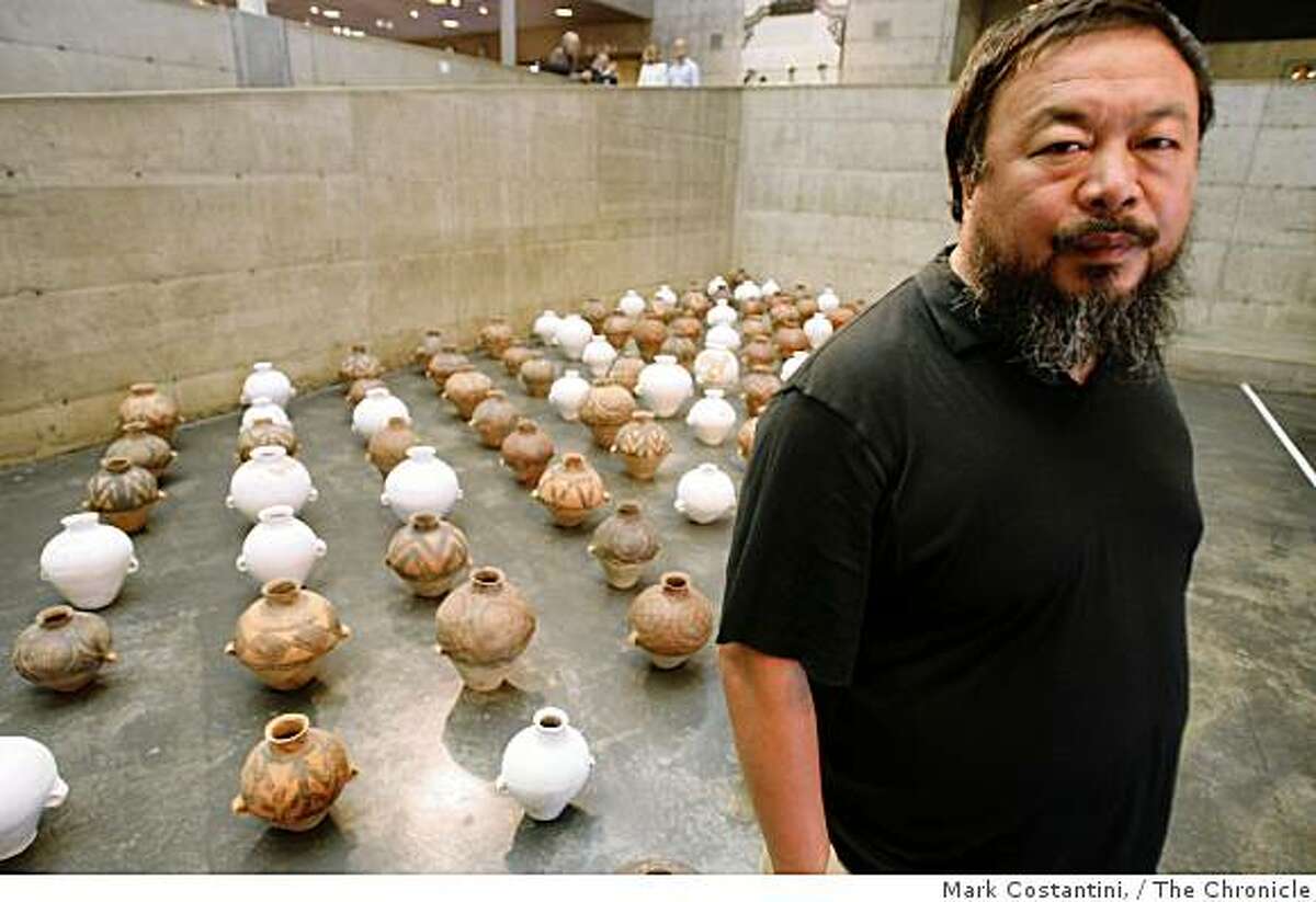 Chinese contemporary artist Ai Weiwei poses with his work, "Whitewash" at the Sigg Collection exhibition at at the Berkeley Art Museum in Berkeley, Calif. on Thursday, September 25, 2008.