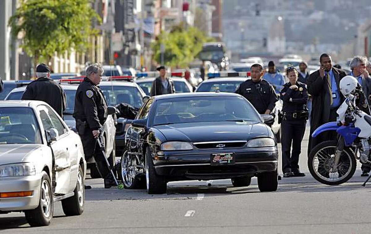 San Francisco Police Department investigators examine the scene of an officer-involved shooting on Folsom Street in San Francisco, Calif., on Monday, April 12, 2010.