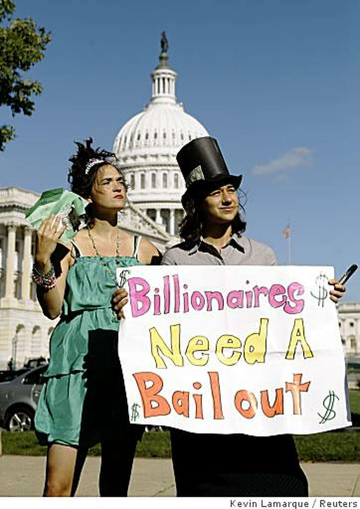 Protesters perform a skit mocking the economic bailout plan in front of the Capitol building in Washington October 2, 2008. The House is expected to vote Friday on the $700 billion financial rescue plan which was passed by the Senate last night. REUTERS/Kevin Lamarque (UNITED STATES)